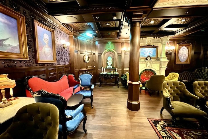 The Haunted Mansion Parlor, featuring ghoulishly delightful “spirits.”